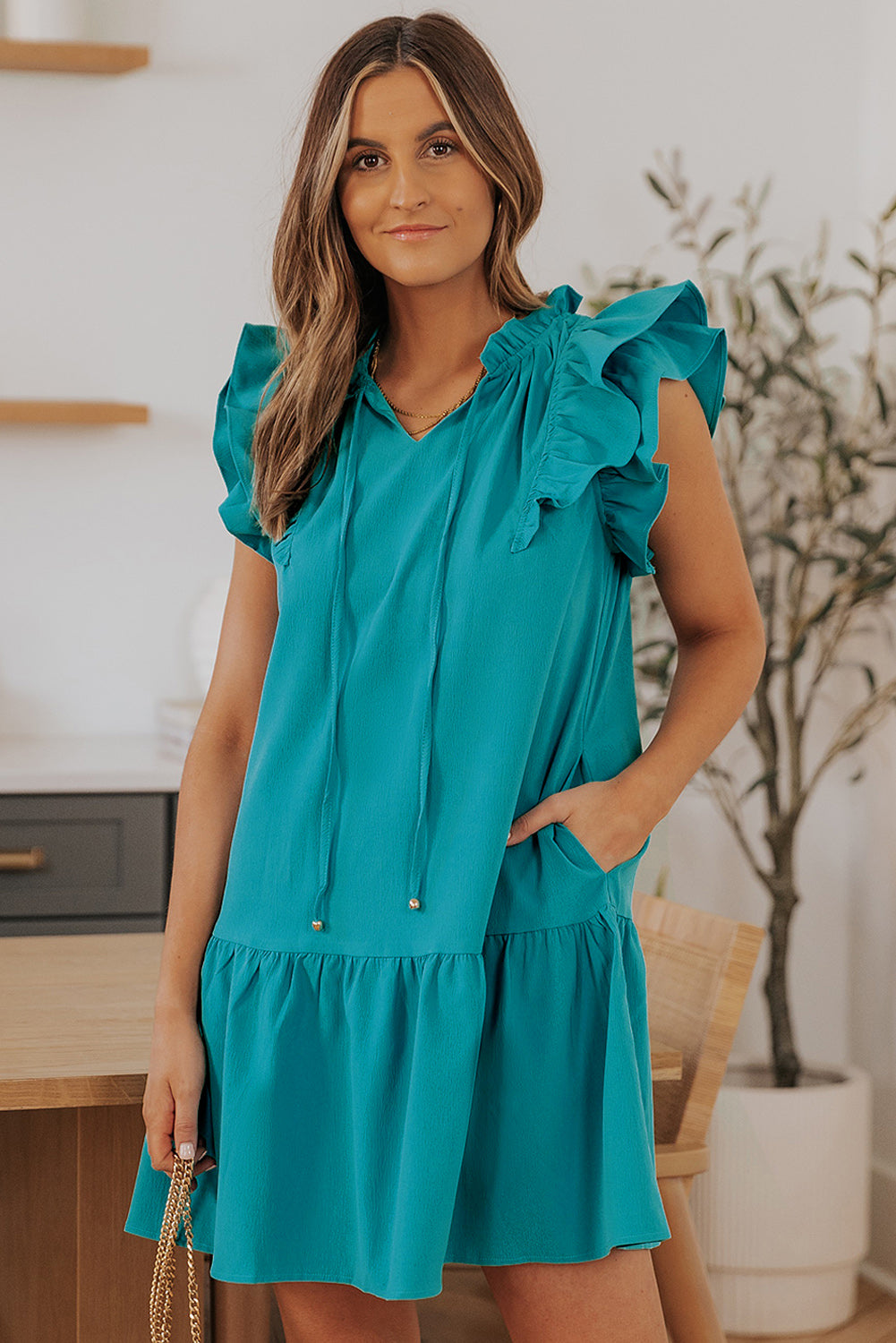Stylish Green Tiered Mini Dress with Ruffled Sleeves and Practical Pockets