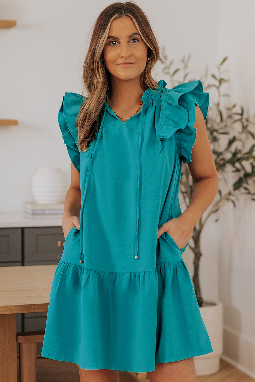 Stylish Green Tiered Mini Dress with Ruffled Sleeves and Practical Pockets