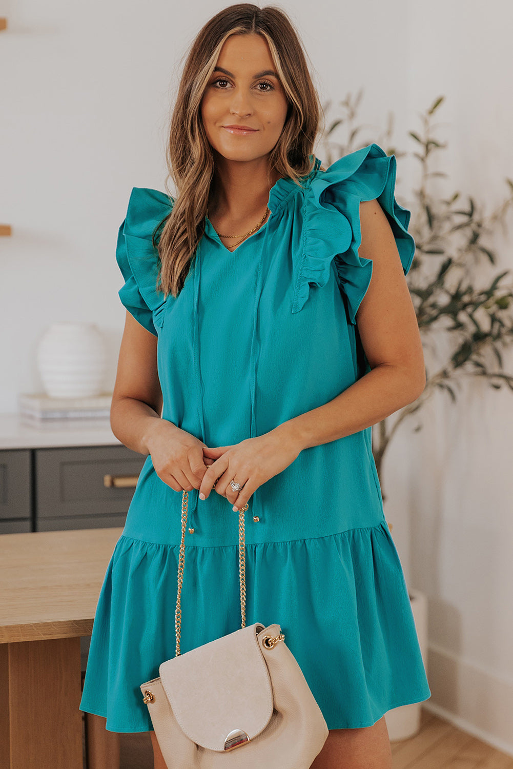 Stylish Green Tiered Mini Dress with Ruffled Sleeves and Practical Pockets